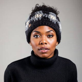Woman wearing a buffalo plaid satin lined winter headband in black, gray, and white.