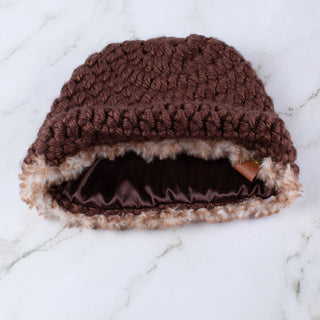 Brown satin lined winter hat with a brown and white faux fur trim.