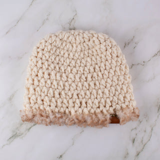 Cream satin lined winter hat with a brown and white faux trim.