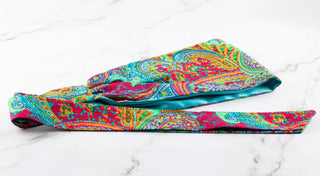 Satin lined headband in turquoise, maroon, green, and orange.