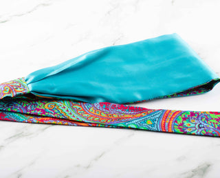 Satin lined headband in turquoise, maroon, green, and orange.