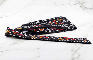 Satin lined headband in black, white, maroon, and orange.