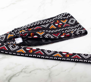 Satin lined headband in black, white, maroon, and orange.