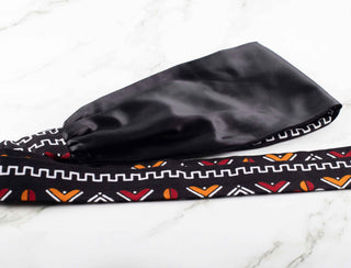 Satin lined headband in black, white, maroon, and orange.