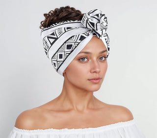 Woman with natural hair wearing a satin lined headband in white and black.
