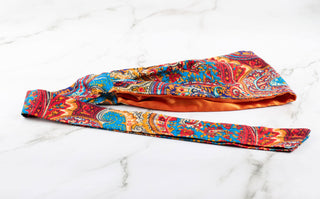 Satin lined headband in orange, blue, and red.