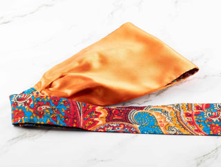 Satin lined headband in orange, blue, and red.