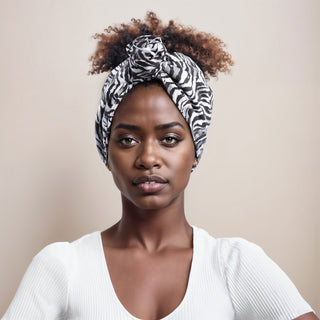 Woman with natural hair wearing a satin lined headband in white and black - White Tiger Print.